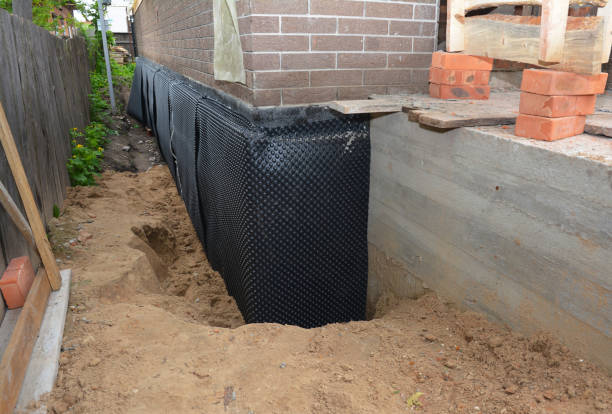 Happy homeowners after waterproofing job in Oswego